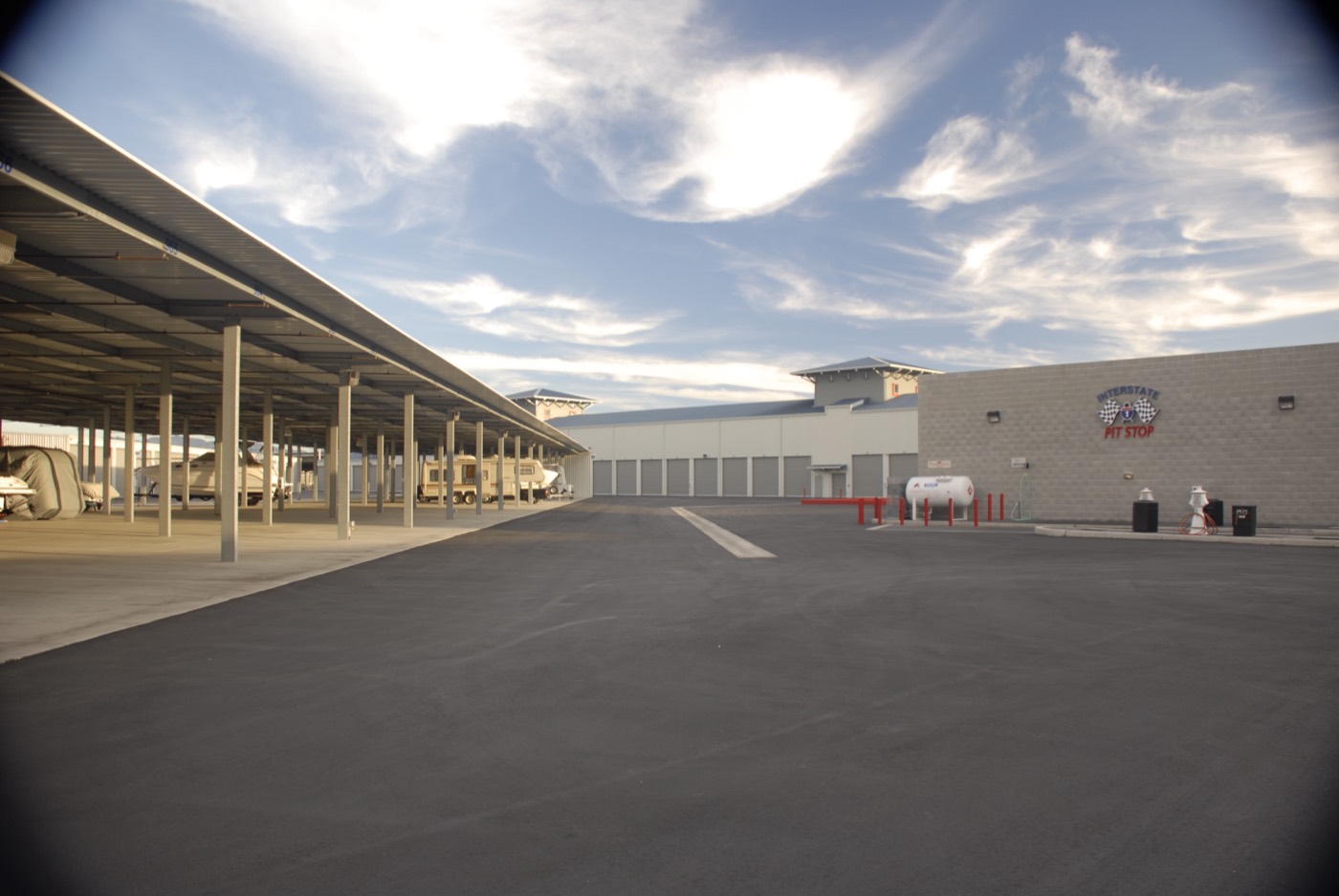 Paved drive aisle between carports and storage buildings